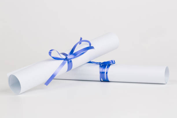 istock Rolled diploma or paper with blue ribbon 669444684
