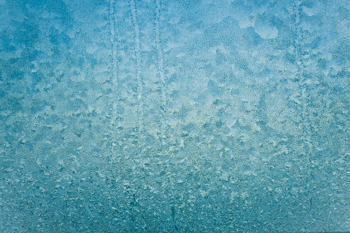 frost and ice  patterns on window,glass coverd with ice