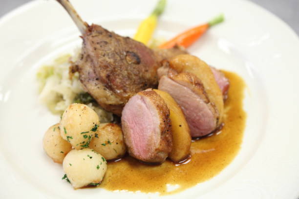 istock Duck leg confit and breast with caramelized apple, savoy cabbage, carrots rissole potato. 669448264