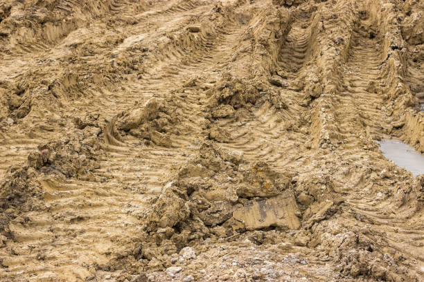 istock Truck tyre pattern on the frozen soil background 669452536