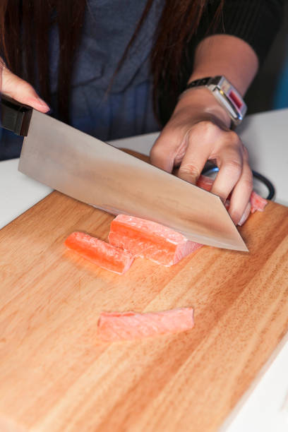 istock Hand using knife cutting freeze salmon meat 669455862
