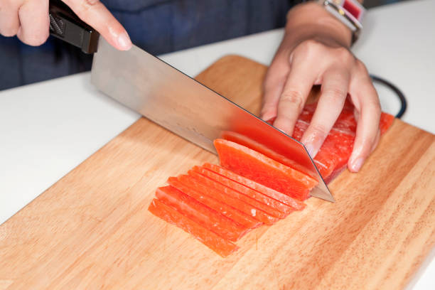 istock Hand using knife cutting freeze salmon meat 669455966