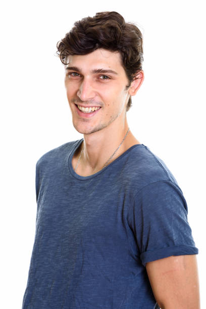 Studio shot of young happy handsome man smiling and looking at camera vertical shot
