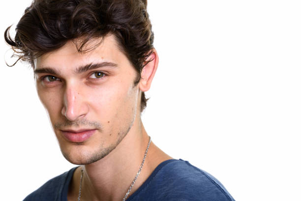 emotions of a handsome man guy on a green background chromakey close-up dark hair young man Portrait of a handsome young man against. High quality photo