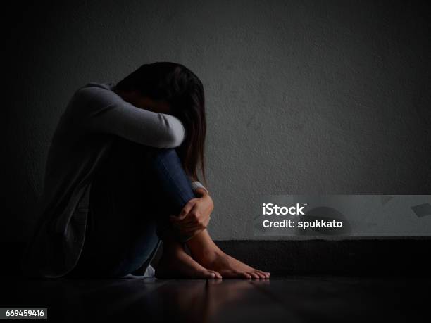 Sad Woman Hug Her Knee And Cry Sad Woman Sitting Alone In A Empty Room Stock Photo - Download Image Now