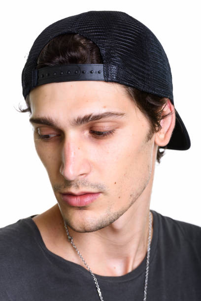 istock Face of young handsome man thinking and wearing cap while looking down 669459590