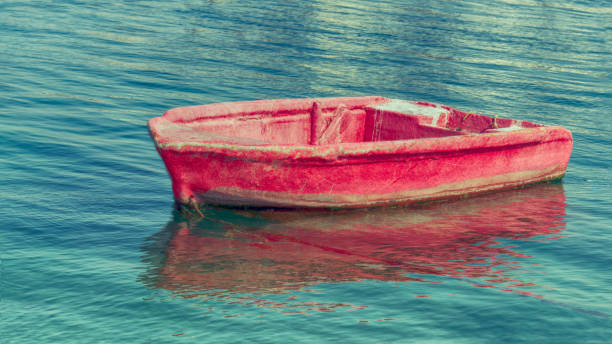 small old red fishing boat at sunrise on the Dubai creek
