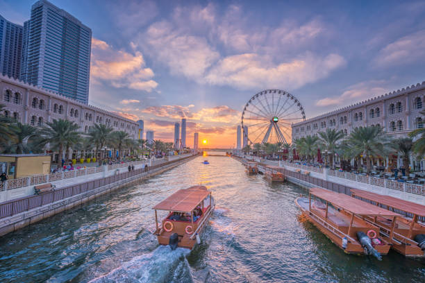 Eye of the Emirates - Ferris wheel in Al Qasba - Shajah at sunset Eye of the Emirates - Ferris wheel in Al Qasba - Shajah at sunset emirate of sharjah stock pictures, royalty-free photos & images