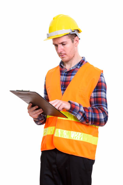 istock Studio shot of man construction worker reading on clipboard 669463270