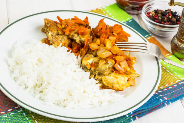 istock Greek baked fish with carrot, onion and rice 669463736