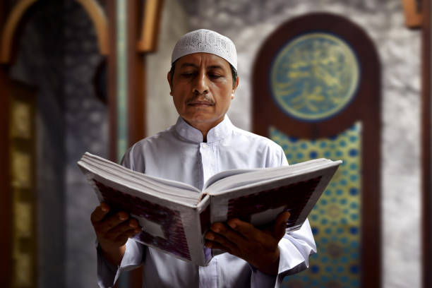 istock Old muslim man reading koran in mosque 669472912