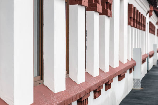 istock Brick wall of old building with row 669473192