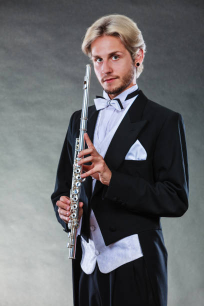 istock Elegantly dressed musician holding flute 669474370