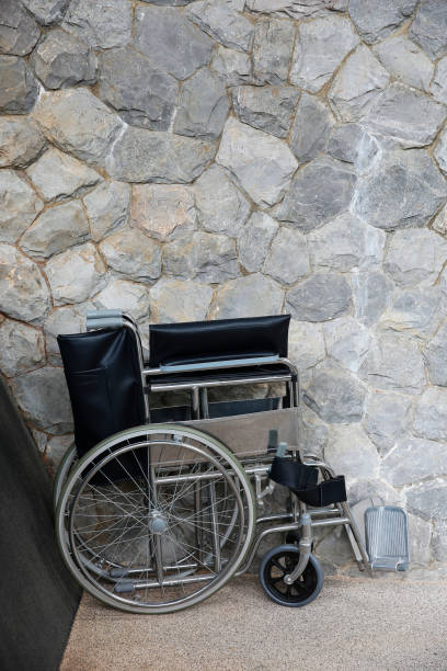 istock Wheelchair support folded in front of wall 669477070