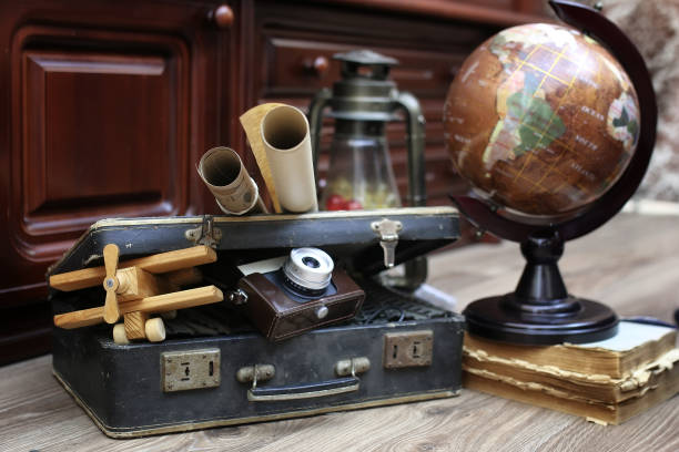 istock composition on a wooden floor vintage globe with old leather sui 669477908