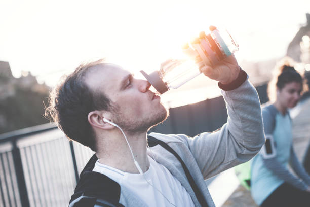 istock Man and woman after urban workout drinking water 669478190