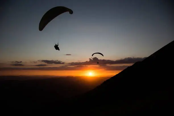 Photo of Paragliders at sunset