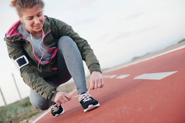 istock Athletic woman tying shoelaces before running 669484072