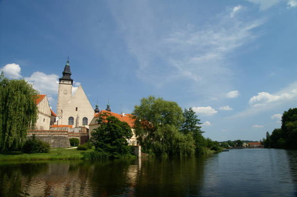 istock Telc Castle and city reflected in lake 669492480