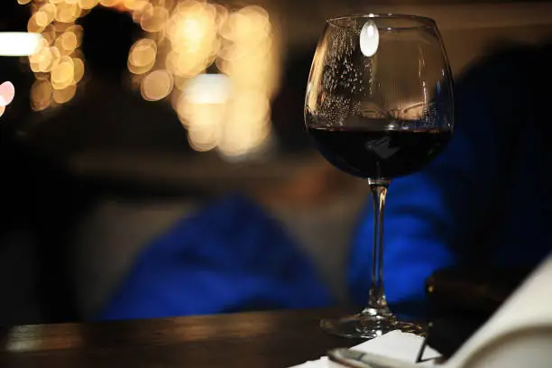 Photo of glass of wine on blured background with circle bokeh