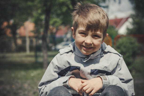 istock Boy smiling in the park 669498700