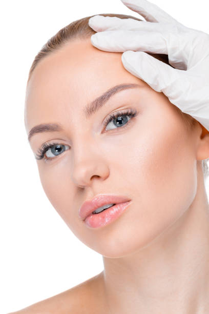 istock cosmetologist examining face of patient 669499336