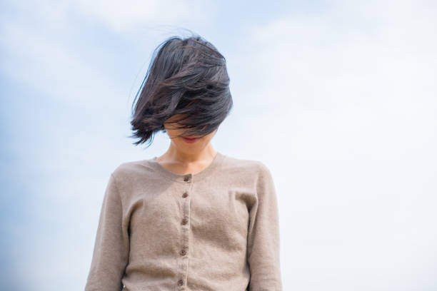 portrait of a young girl with black hair on the beach.