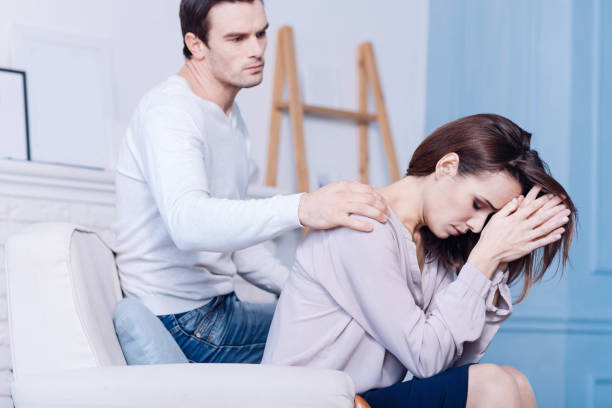 istock Sad young woman touching her forehead 669499478