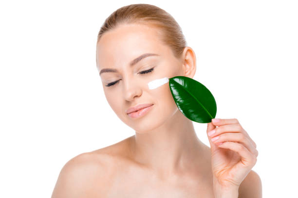 istock woman with cream on face 669502870