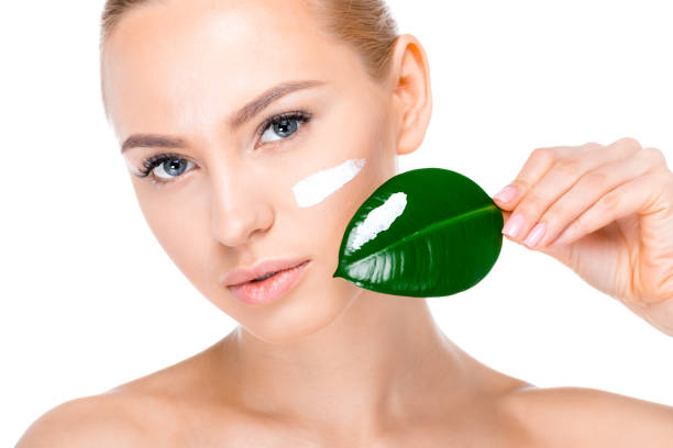 istock woman with cream on face 669505152