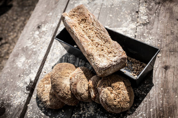istock Freshly baked wholegrain bread on a wooden table background 669505474