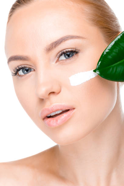 istock woman with cream on face 669505636