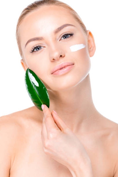 istock woman with cream on face 669505930