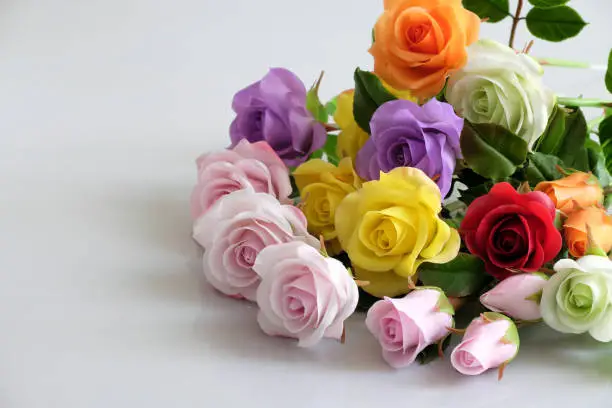 Wonderful clay art with colorful roses flower on white background, beautiful artificial flowers of craftsmanship with skillful