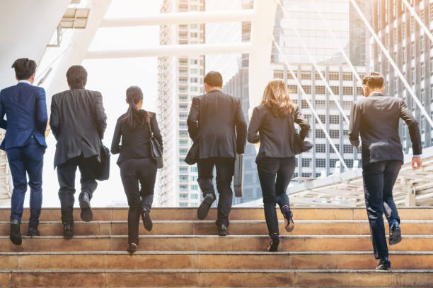 istock Group of Business People Running in Row 669512616