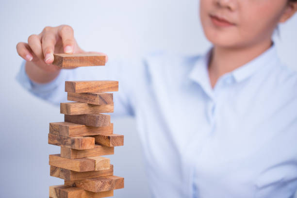 istock Woman build a tower puzzle 669512944