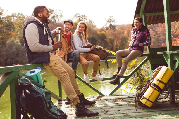 istock Young travelers resting near river 669520036
