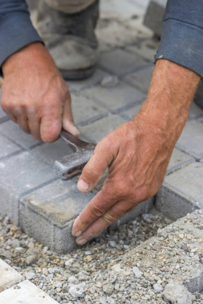 istock laying concrete brick pavers 3 669520892
