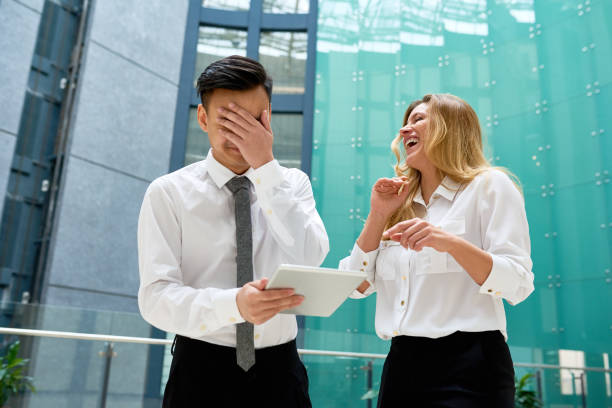 istock Laughing at Young Colleague 669523732