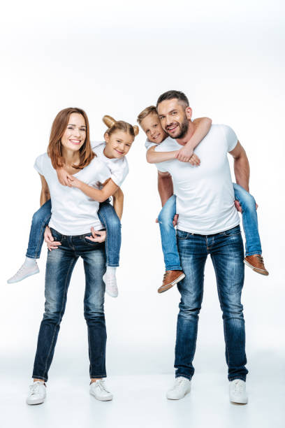 Parents piggybacking happy children