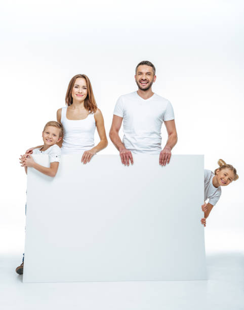 istock Happy family holding blank card 669525724