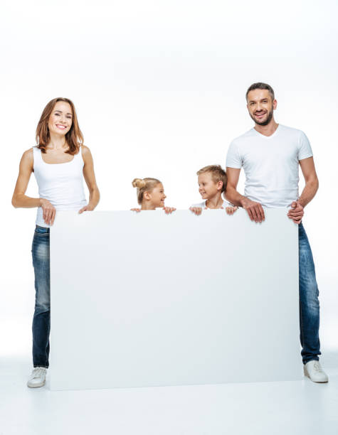 istock Happy family holding blank card 669532744