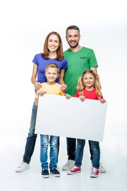 istock family standing with blank white card 669532898
