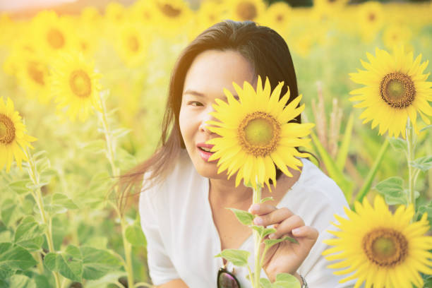 istock Sunflower and a woman hiding behind it 669533130