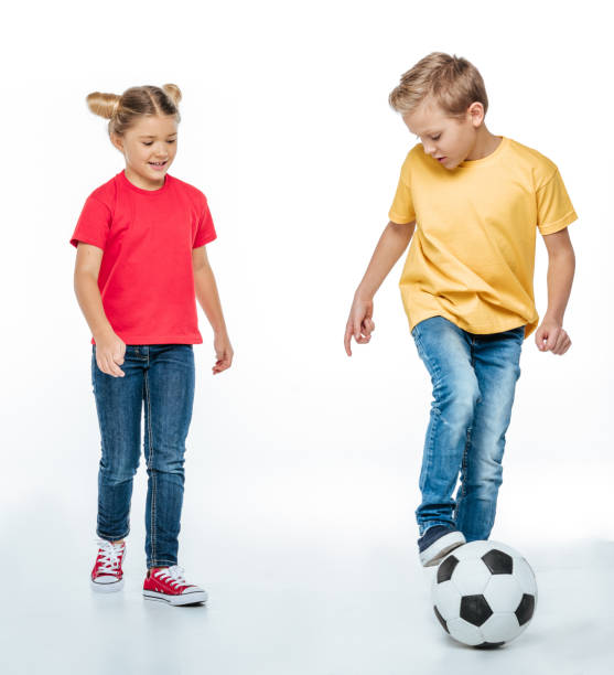 istock siblings playing with soccer ball 669533210