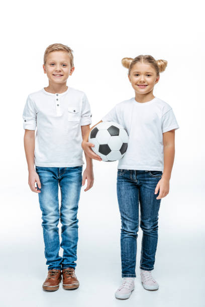 istock Smiling children standing with soccer ball 669533494