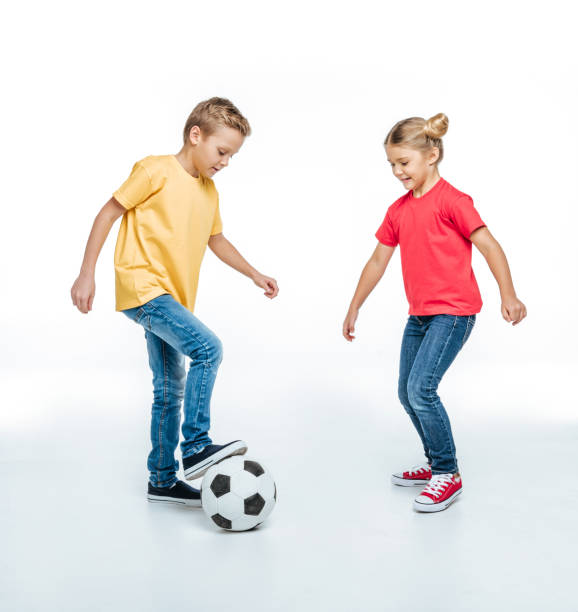 siblings playing with soccer ball