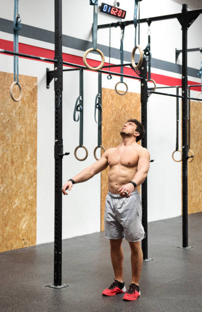 istock Athlete psyching himself up to workout on rings 669534278