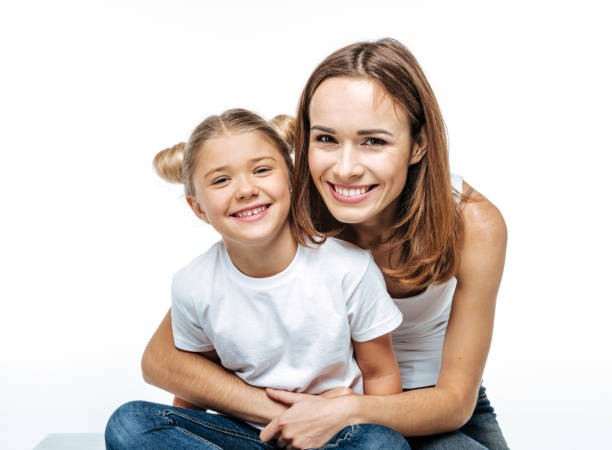 Smiling mother hugging daughter