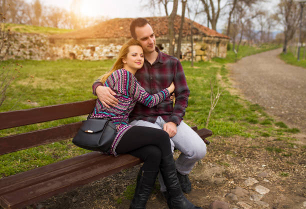 Couple dating in the park at sunset